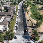 An overview of asphalt paving operations on Monarch Boulevard.