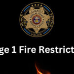 Sheriff's badge with text that reads Stage 1 Fire Restriction.